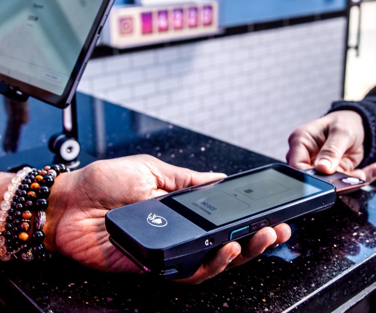 A picture of a customer inserting their card into a card reader