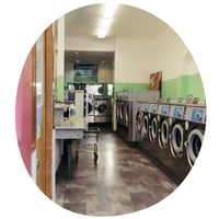 A picture of laundry machines stacked next to each other.