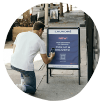 A person scans a QR code outside of a laundromat