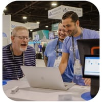 Cents employees gathered around a laptop showcasing the benefits of the platform