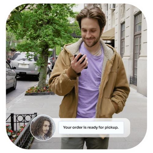 A picture of a man looking at the pickup alert for his laundry