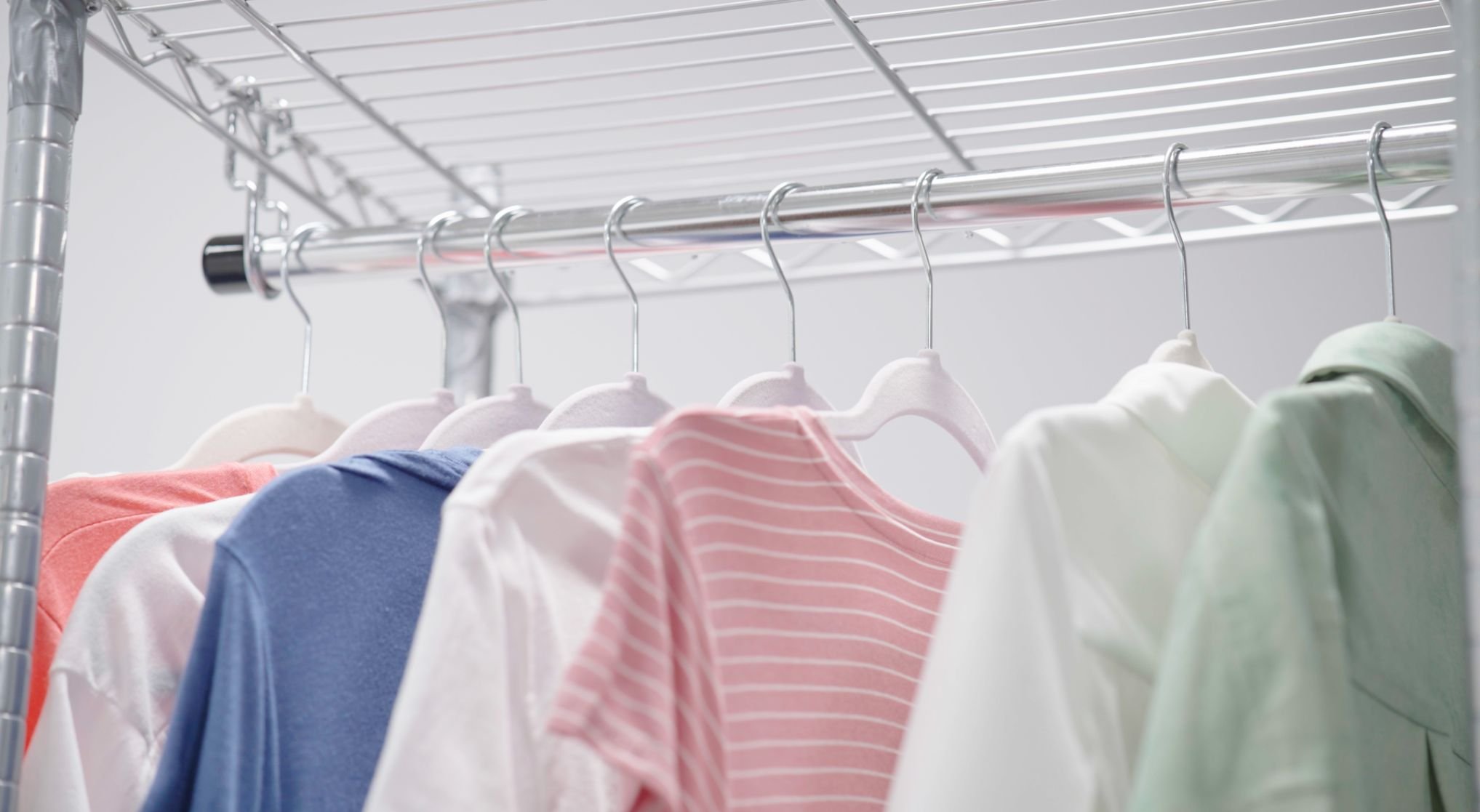 A picture of shirts hanging on a rack