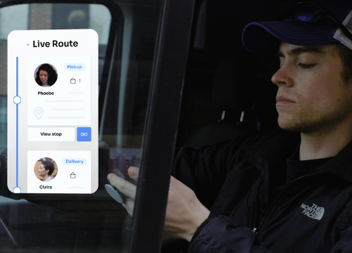 A picture of a pickup and delivery driver checking his driver app with a mockup of the app